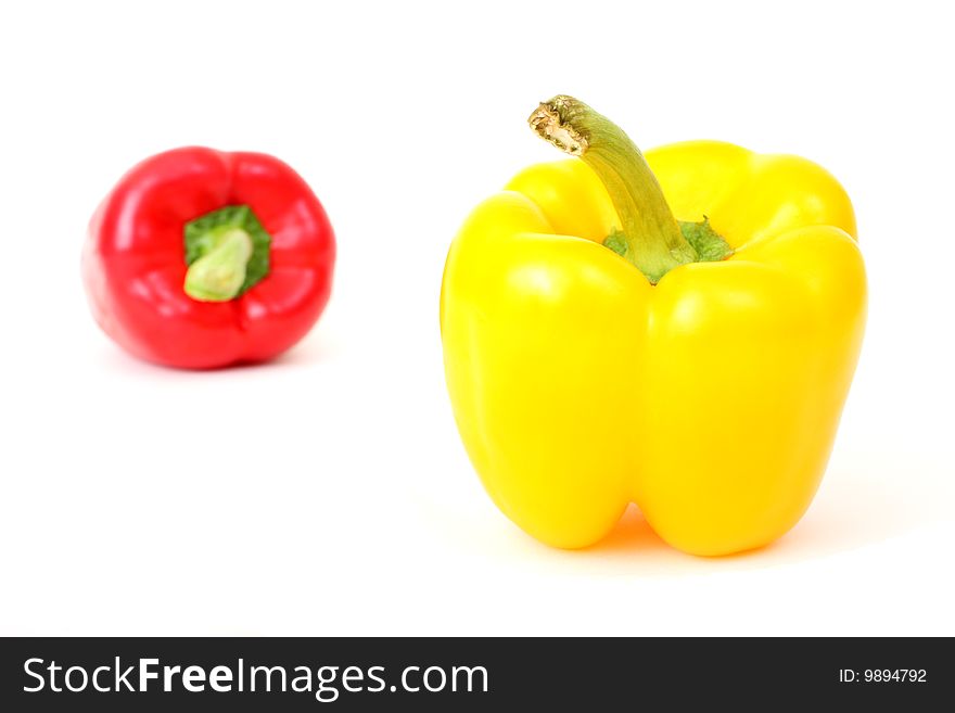 Two fresh paprika (red and yellow) photographed on white background. Two fresh paprika (red and yellow) photographed on white background