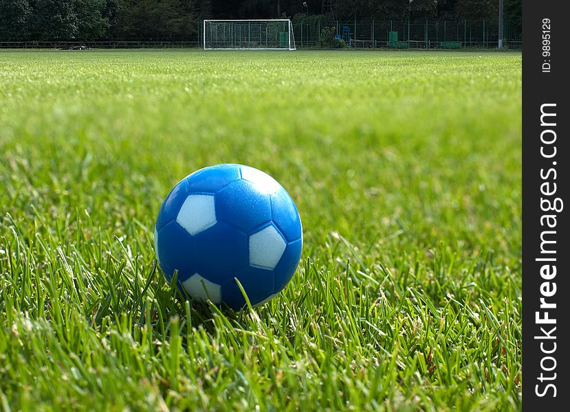 Small blue soccer ball against goal in background