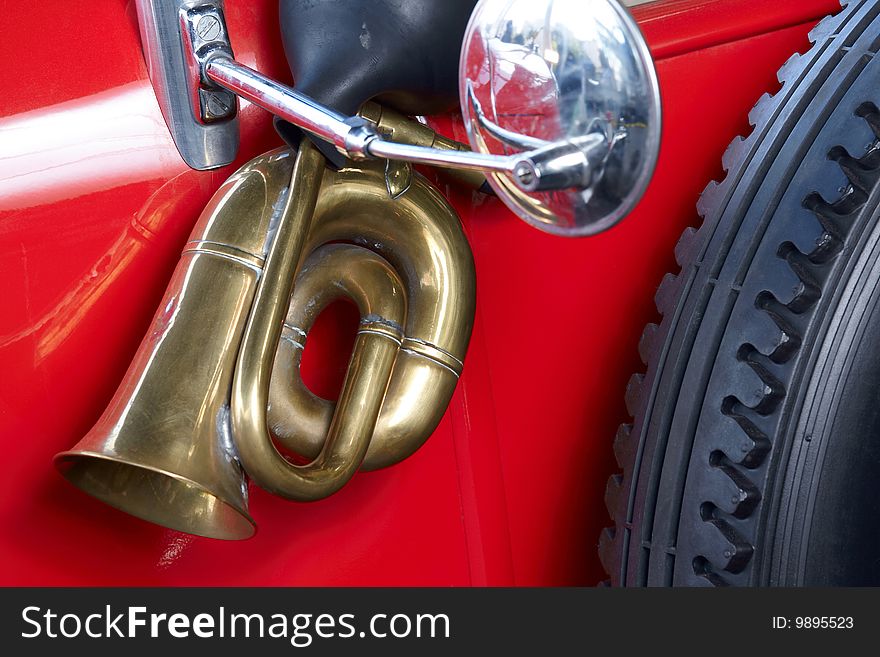 Old red car with brass horn and mirror. Old red car with brass horn and mirror