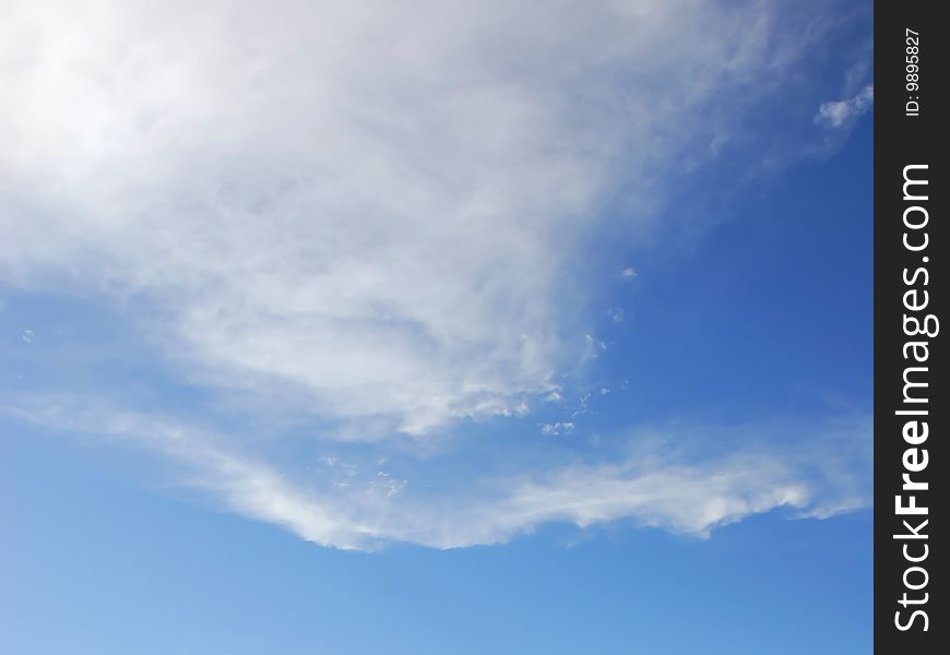 White Cumulus Humilis clouds forming against a blue sky as a young storm develops