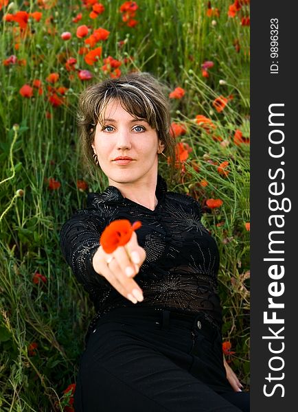 Portrait woman with poppy on nature