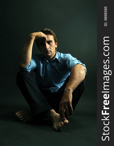 Man meditating in low key over a black background