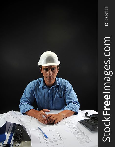 Engineer in low key over a black background