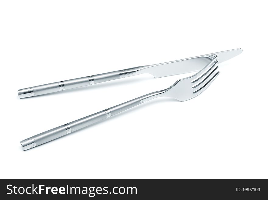 Steel knife and fork on a white background