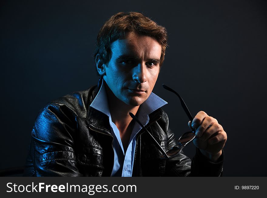 Man portrait in low key over a black background