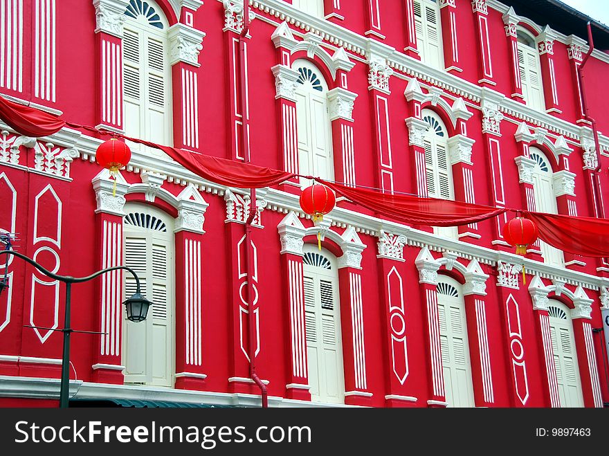 Beautifully restored early 20th century building painted bright red with cream louvered shutters, windows and pilasters in Chinatown - Xu Lei Photo / Lee Snider Photo Images. Beautifully restored early 20th century building painted bright red with cream louvered shutters, windows and pilasters in Chinatown - Xu Lei Photo / Lee Snider Photo Images