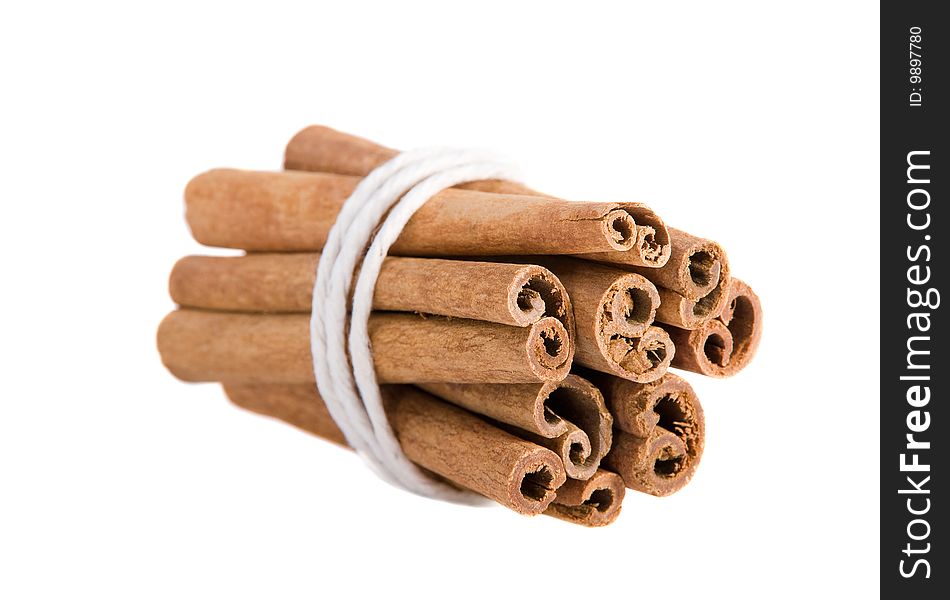 Sticks of cinnamon joined with string on the white background. Sticks of cinnamon joined with string on the white background