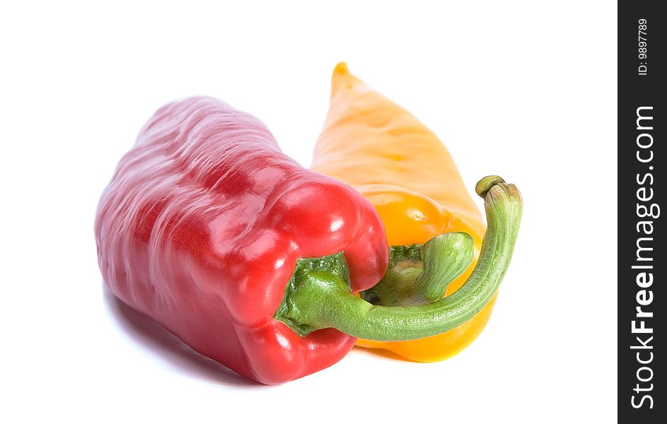 Red and yellow sweet peppers on white background