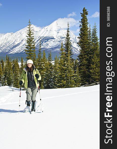 Woman snowshoeing in the Canadian rockies, british columbia