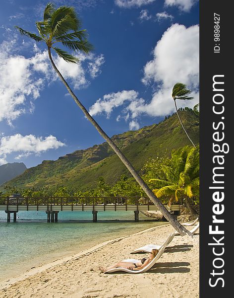 Girl laying on a beach in Moorea , Franch Polyensia