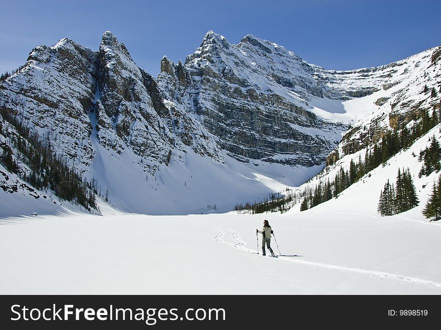 Woman snowshoeing in the Canadian rockies, near Lake Louise, Alberta