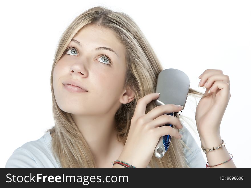 Beautiful young woman combing her hair