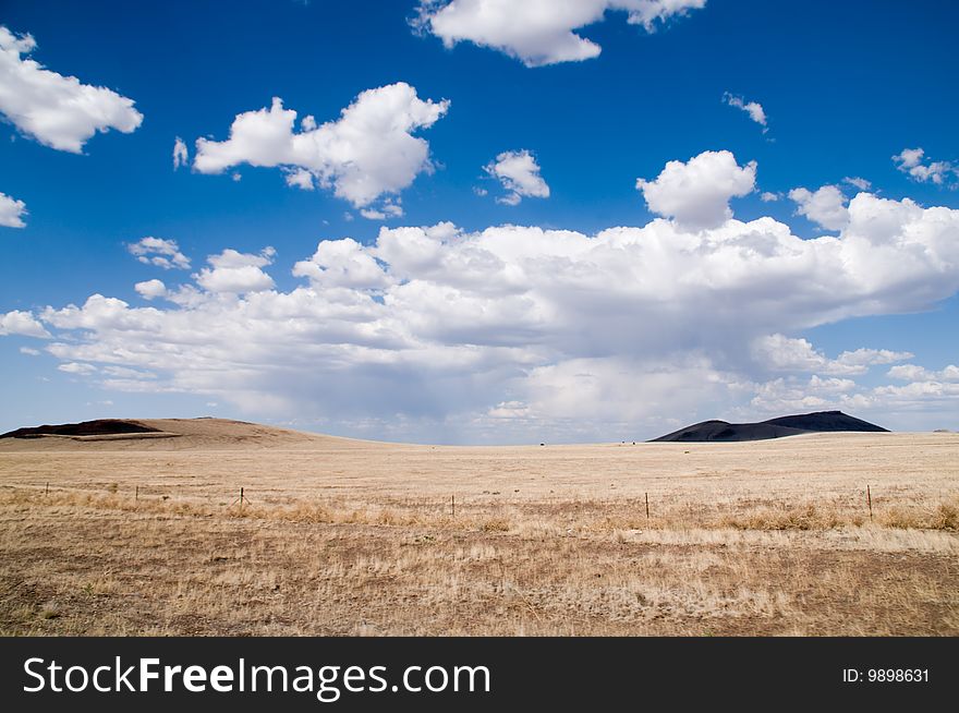 A vast landscape of an approaching storm on a ranch in New Mexico. A vast landscape of an approaching storm on a ranch in New Mexico.