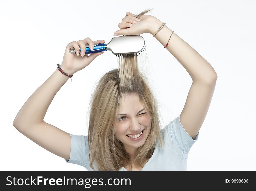 Beautiful young woman combing her hair