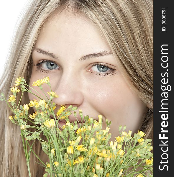 Young happy woman with bouquet of yellow flowers, isolated