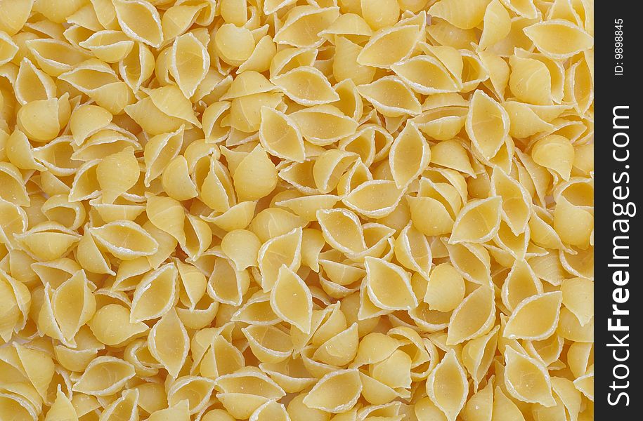 A lot of pasta small shell as back ground. A lot of pasta small shell as back ground