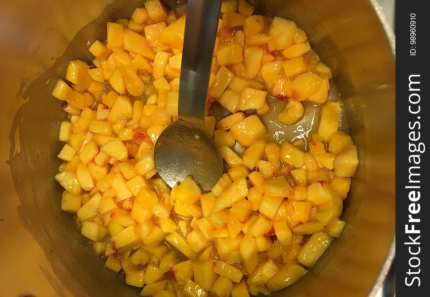 Peaches cooking with pectin, lemon juice, and butter