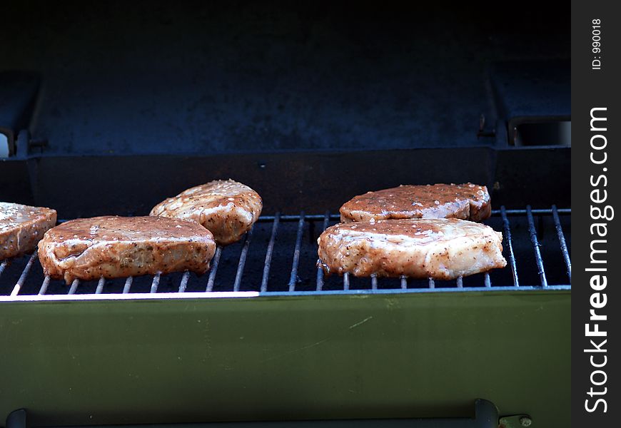 Steaks just started cooking on the grill.  Don't they look delicious?. Steaks just started cooking on the grill.  Don't they look delicious?