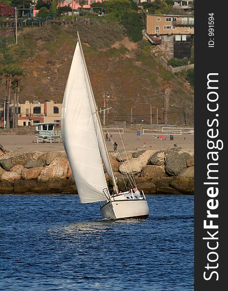 Reaching sailboat, along the coast