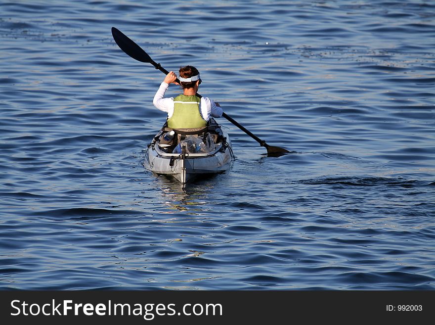 Woman paddling on a sea kayak