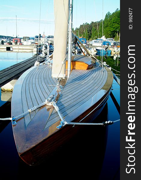 Classic wooden sailboat with teak-deck at a yacht harbour