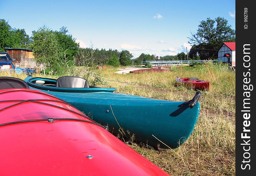 Canoes wait on the river bank. Canoes wait on the river bank
