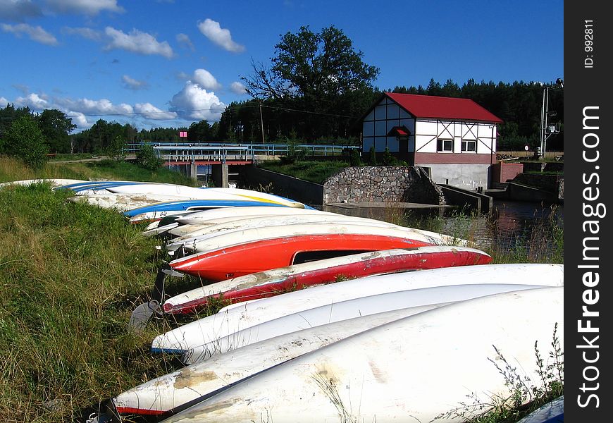 Canoes wait on the river bank. Canoes wait on the river bank