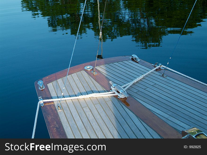 Rear end of classic, wooden sailboat with teak-deck. Rear end of classic, wooden sailboat with teak-deck