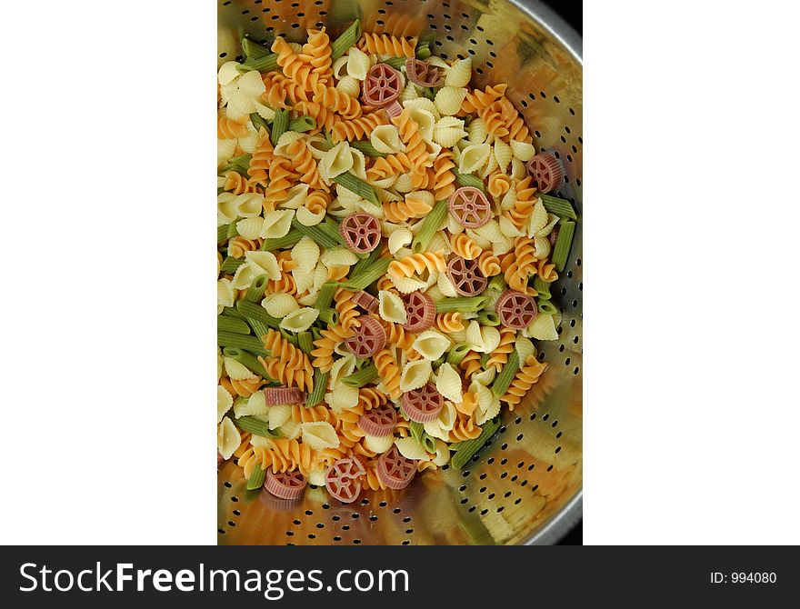 Looking into bowl of freshed cooked noodles of various colors. Looking into bowl of freshed cooked noodles of various colors