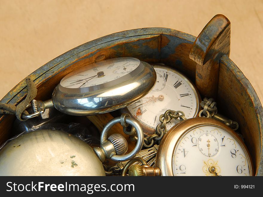 Looking down on assortment of old pocket watches in handmade wooden box. Looking down on assortment of old pocket watches in handmade wooden box