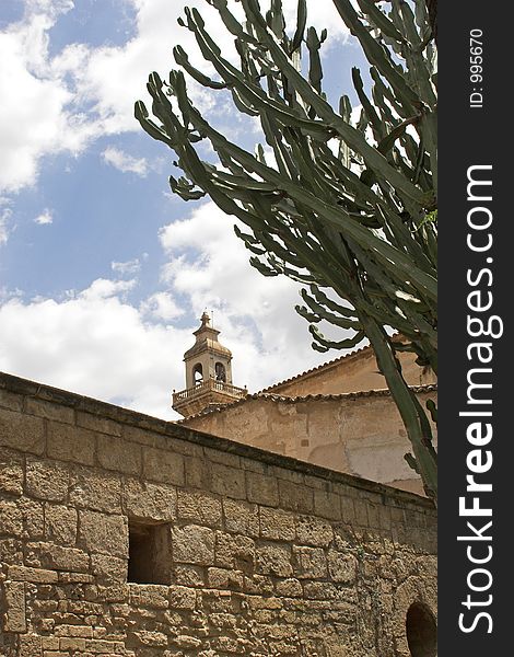 Old spanish building with tower and cactus in foreground. Old spanish building with tower and cactus in foreground