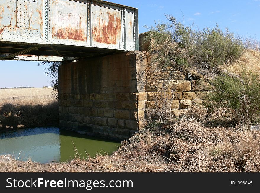 Steel railroad bridge build onto sandstone