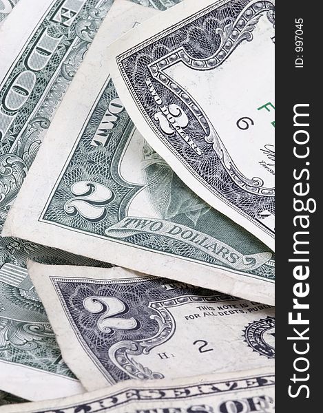 Pile of two dollar bills (and a one dollar bill) - vertical format. Pile of two dollar bills (and a one dollar bill) - vertical format