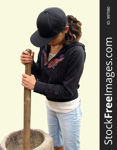 Girl churing an old corn grinder.