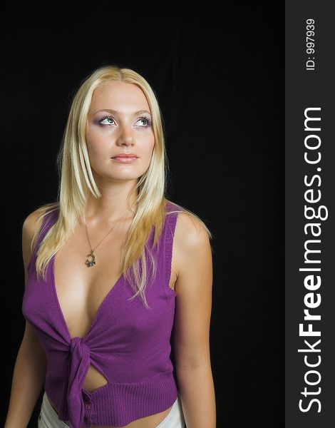 Attractive blond model on black background - violet top
