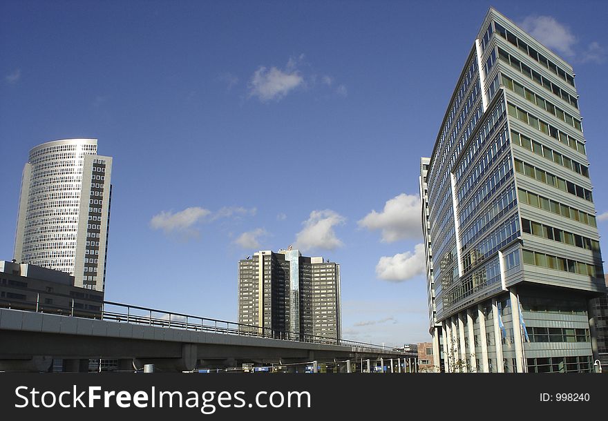 A picture of a cople of futuristic office buildings, with a blue sky as back ground. A picture of a cople of futuristic office buildings, with a blue sky as back ground.