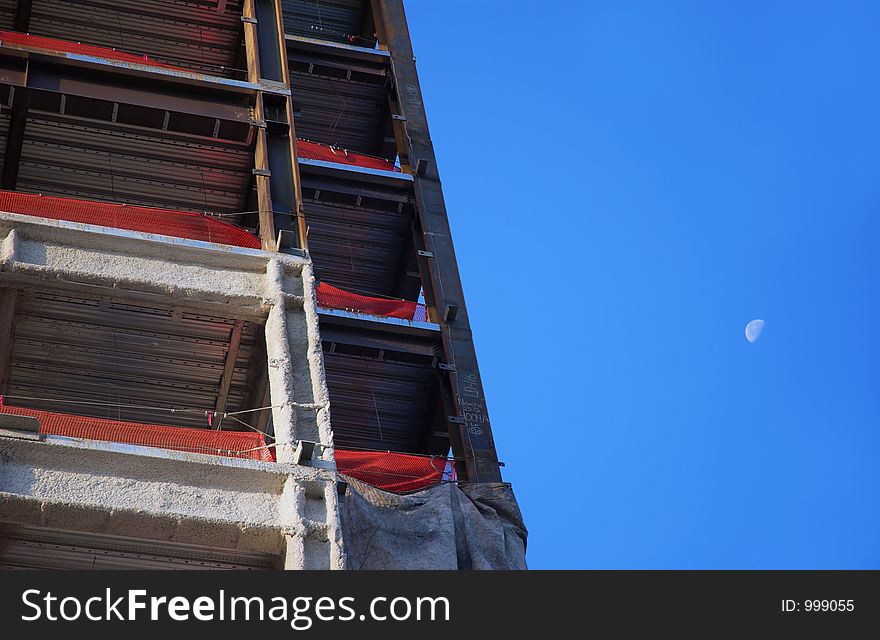 Corporate building under construction with moon