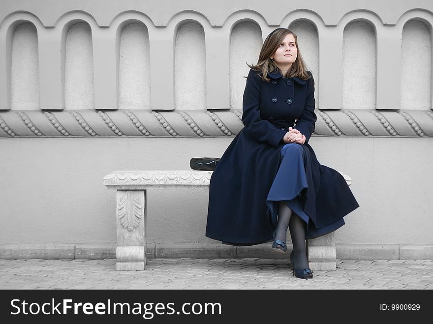 Woman sitting on stone bench