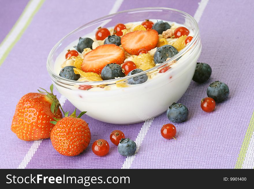 Bowl of corn flakes with fresh fruits and jogurt. Bowl of corn flakes with fresh fruits and jogurt