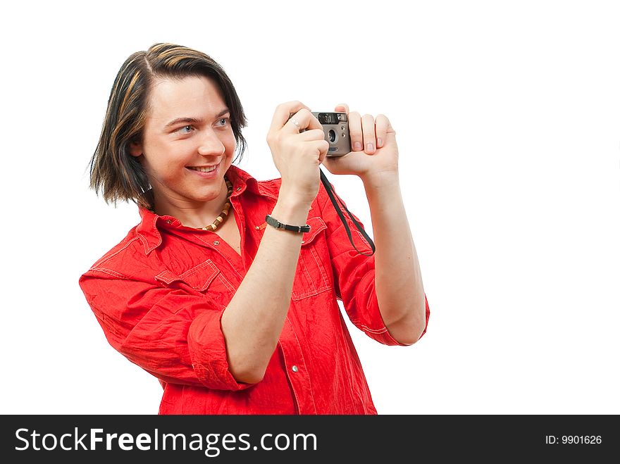 Young guy photographs something. Isolated over white in studio.