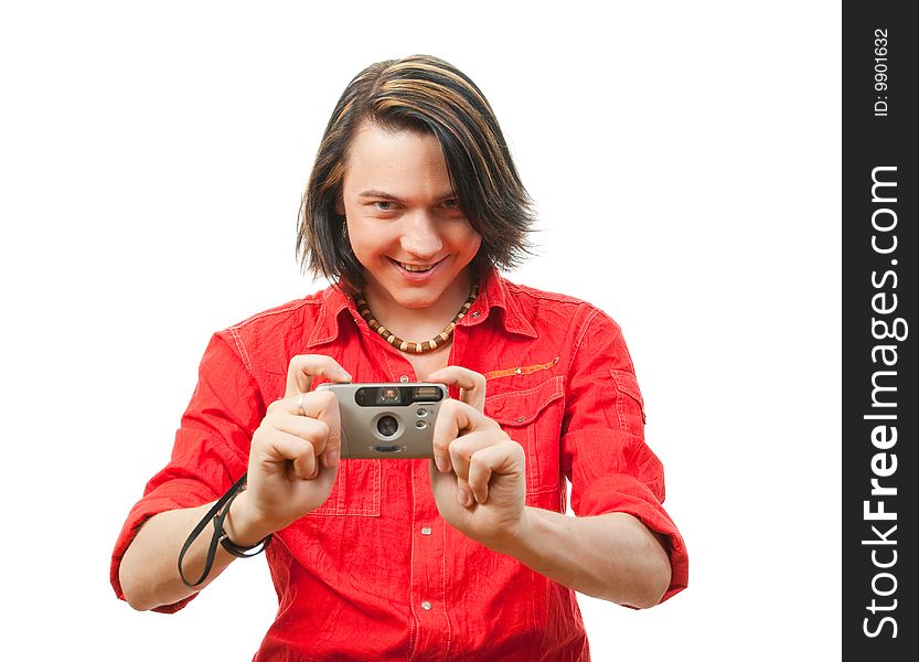 Young guy photographs something. Isolated over white in studio.