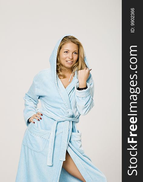 A girl is dressed in a blue bath-house dressing-gown