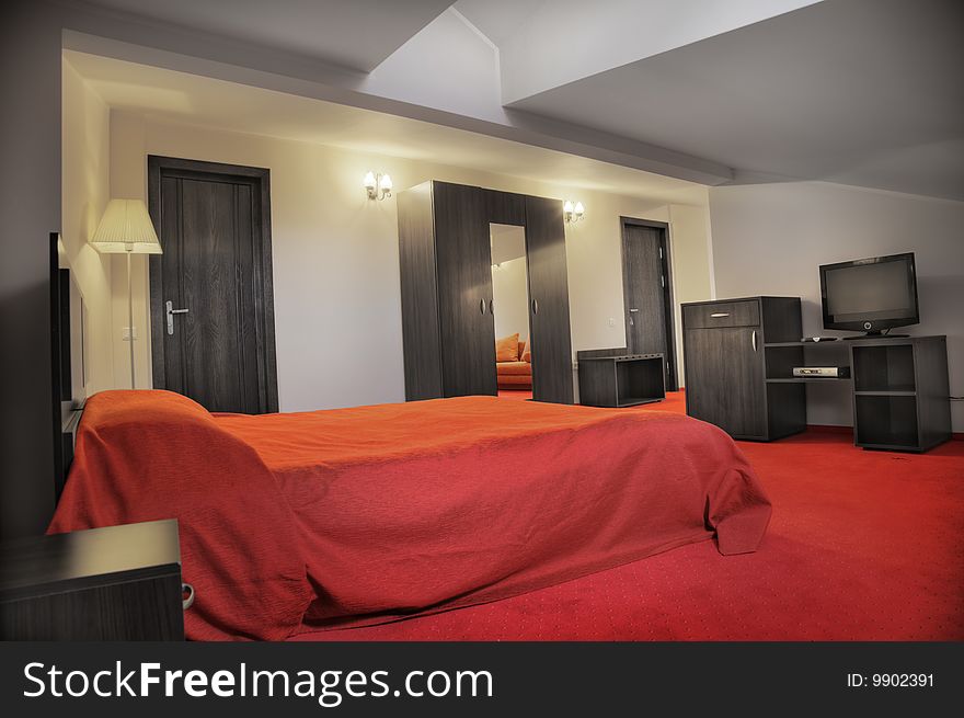 Hotel bedroom in colors red and grey empty