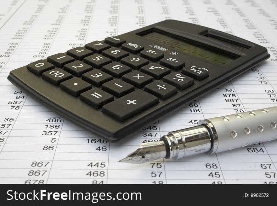 Calculator and pen on a white background. Calculator and pen on a white background