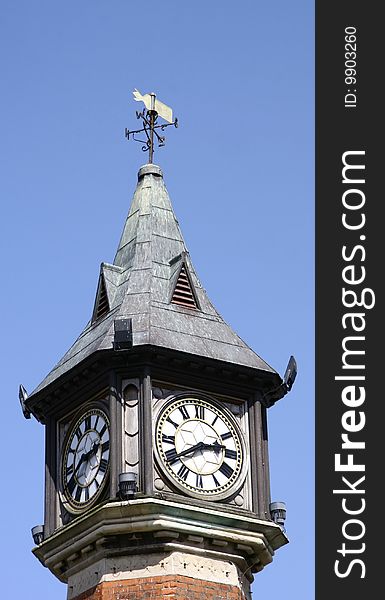 Top of a clock tower showing two faces