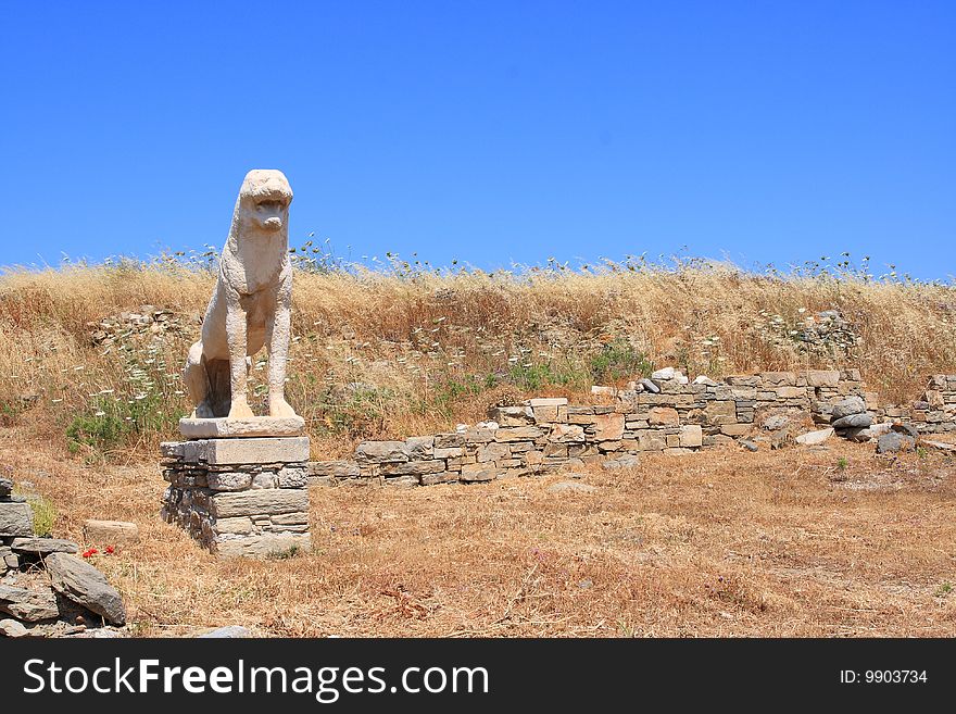 The island of Delos, isolated in the centre of the roughly circular ring of islands called the Cyclades, near Mykonos, is one of the most important mythological, historical and archaeological sites in Greece.

The Terrace of the Lions dedicated to Apollo by the people of Naxos shortly before 600 BC, had originally nine to twelve squatting, snarling marble guardian lions along the Sacred Way; one is inserted over the main gate to the Venetian Arsenal. The lions create a monumental avenue comparable to Egyptian avenues of sphinxes. (There is a Greek sphinx in the Delos Museum.). The island of Delos, isolated in the centre of the roughly circular ring of islands called the Cyclades, near Mykonos, is one of the most important mythological, historical and archaeological sites in Greece.

The Terrace of the Lions dedicated to Apollo by the people of Naxos shortly before 600 BC, had originally nine to twelve squatting, snarling marble guardian lions along the Sacred Way; one is inserted over the main gate to the Venetian Arsenal. The lions create a monumental avenue comparable to Egyptian avenues of sphinxes. (There is a Greek sphinx in the Delos Museum.)