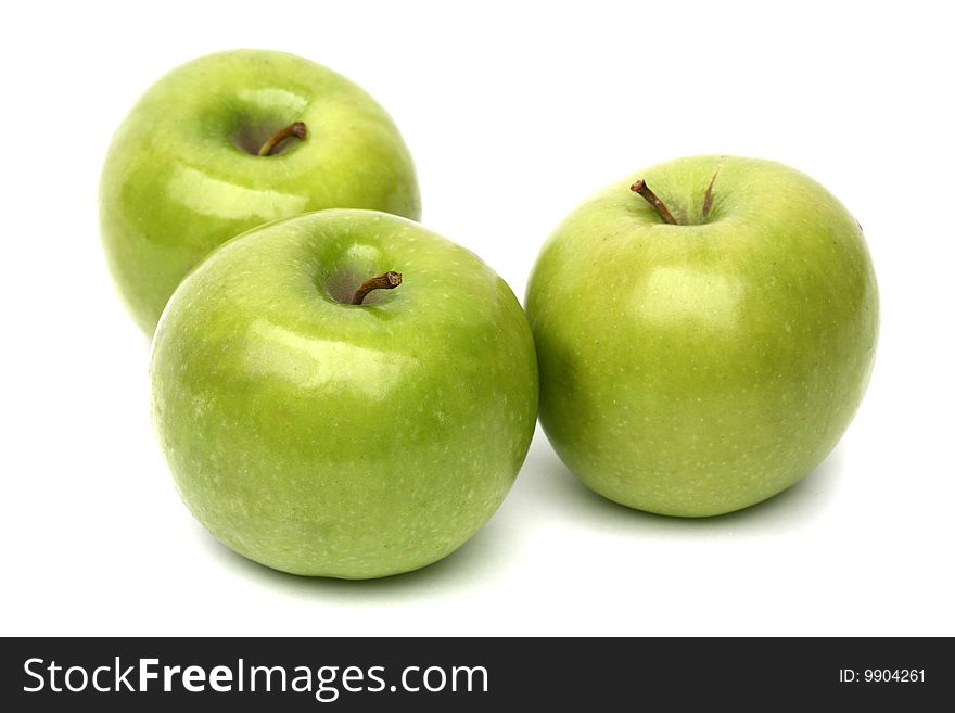 Tree green apples isolated on white