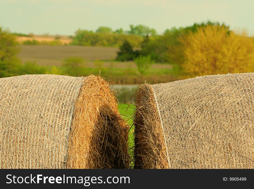 Two round bales with rural Nebraska landscape. Two round bales with rural Nebraska landscape