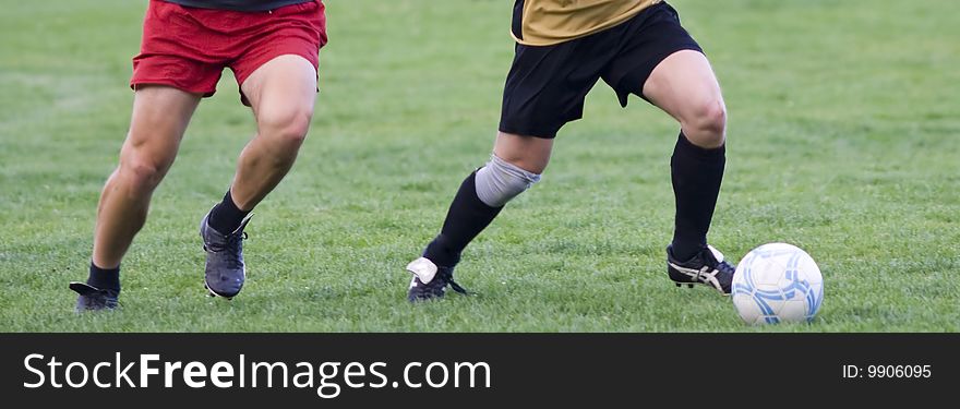 Soccer players fighting for the ball