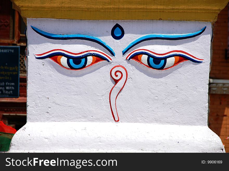 Buddha eyes painted on the base of the golden tower on the Bodhnath Buddhist Temple in Kathmandu, Nepal.